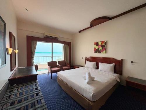 En eller flere senge i et værelse på Penang Rainbow Paradise