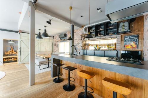 an open kitchen with a bar and a dining area at Cellar 88 in Sonogi