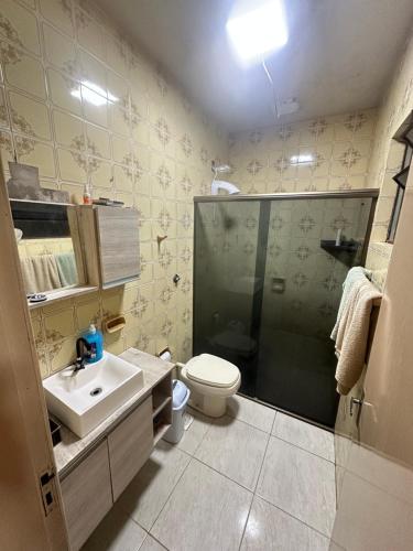 a bathroom with a shower and a toilet and a sink at pousada cardoso - casa 2 in São Gabriel