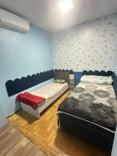 a room with two beds and a bench in it at pousada cardoso - casa 2 in São Gabriel