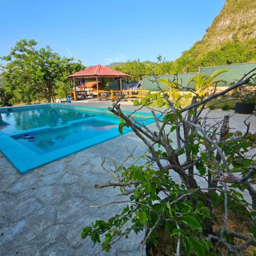 een zwembad in een resort met een prieel bij Villa Monte Alba in San Felipe de Puerto Plata