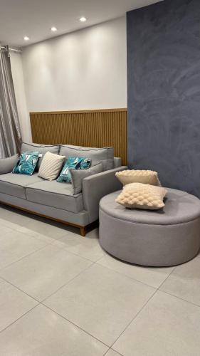 a living room with a couch and a table at Guarajuba Acqua 103 in Camacari