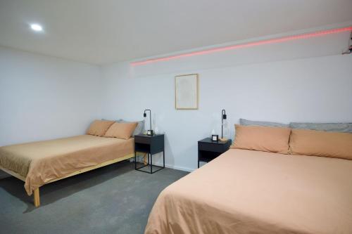 a room with two beds and two night stands at Tathra Bermagui Road 613 in Tathra