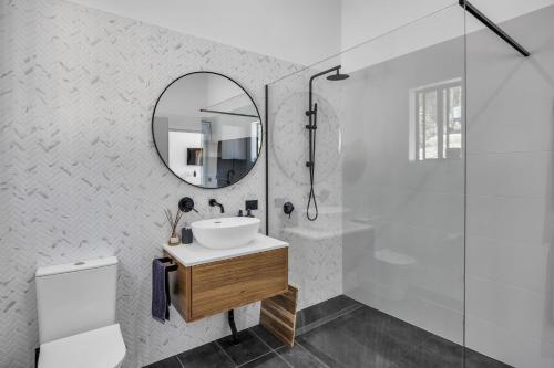 a bathroom with a sink and a mirror at Tathra Bermagui Road 613 in Tathra