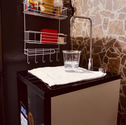 a counter with a glass on top of a refrigerator at KUHA home in Nha Trang