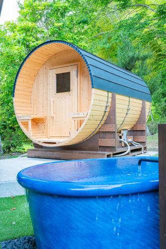 a small wooden play house with a slide at サウナ付き古民家の宿 和ごろも - Kominka no yado Wagoromo - in Ōtaki