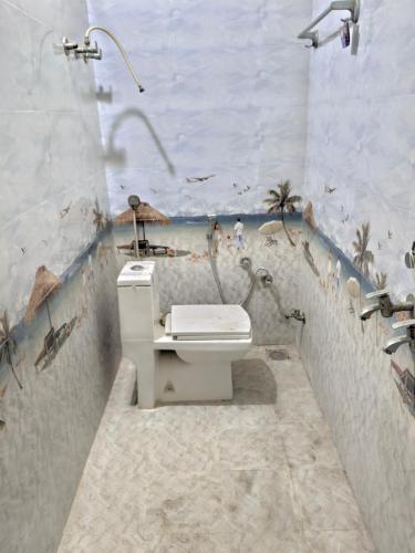 a bathroom with a toilet and a sink and a shower at Avs Jain's house in Ujjain