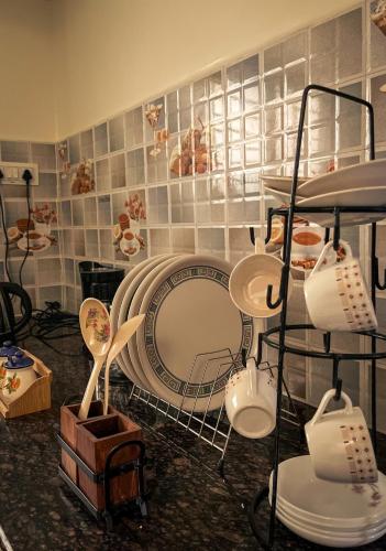 a room with a table and some dishes on display at Payaringal House Botanical Garden White Town Promenade Beach in Pondicherry