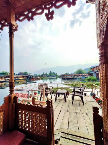 a porch with chairs and a view of a body of water at Houseboat Ambassador in Srinagar