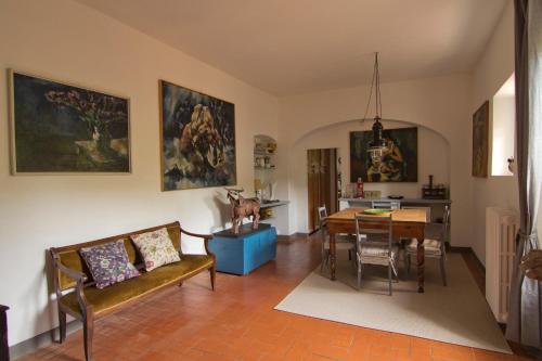 a living room with a table and a dining room at Il Monasteraccio in Florence