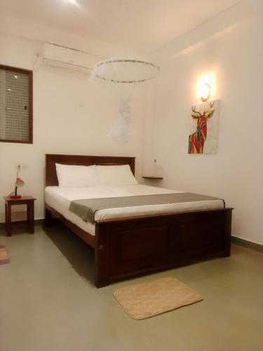 a bedroom with a large bed in a room at The ED Corner - Hiriketiya in Dickwella