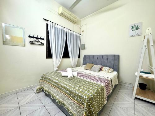 En eller flere senge i et værelse på Simee Cozy Homestay ,Simee, Ipoh Town