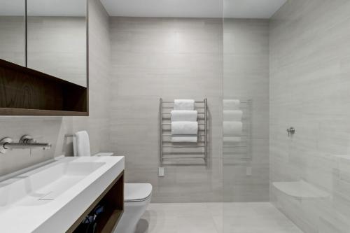 a bathroom with a sink and a toilet and a shower at Belle Vue Villa - Stunning Views with Hot Tub in Queenstown