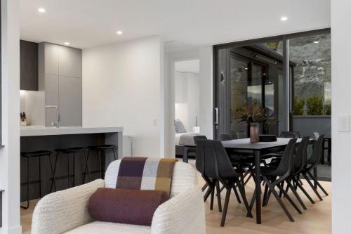 a kitchen and dining room with a table and chairs at Belle Vue Villa - Stunning Views with Hot Tub in Queenstown