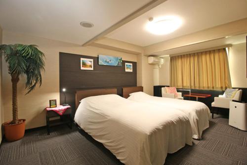 Postel nebo postele na pokoji v ubytování ウェルカムイン湯本