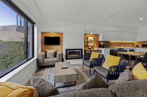 a living room with a couch and a fireplace at Residence Du Parc - Apt 6b at the base of Coronet Peak in Queenstown