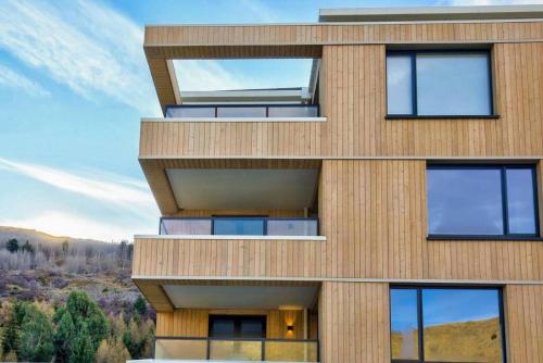 an exterior view of a building with windows at Residence Du Parc - Awa Apt 16a in Queenstown