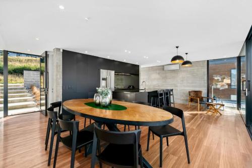 a kitchen and dining room with a table and chairs at St Marks Stunning Views Queenstown in Queenstown