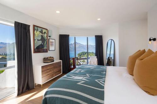 a bedroom with a bed and a large window at Edinburgh 3BR 2BA with Hot Tub Views Fireplace in Queenstown