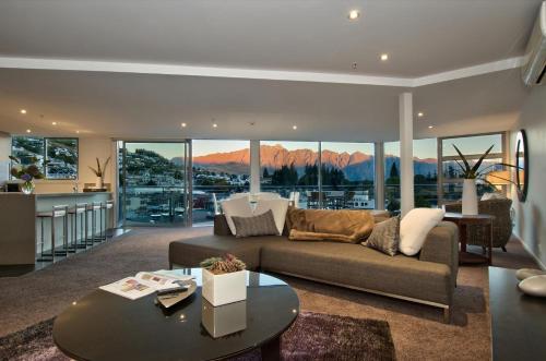 a living room with a couch and a table at Bay View Condo in Queenstown