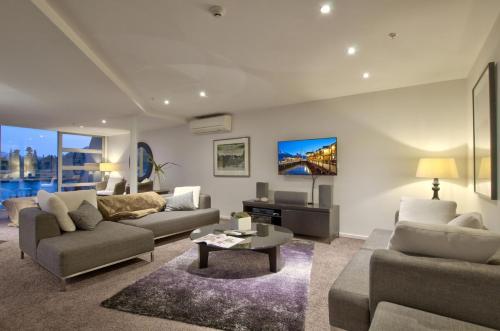 a living room with a couch and a table at Bay View Condo in Queenstown