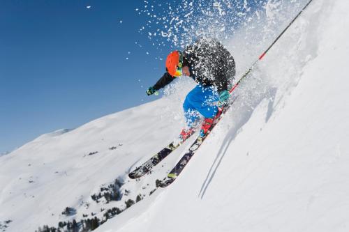 a person is skiing down a snow covered slope at Ski- und Wander Appartements Schiffer in Innerkrems