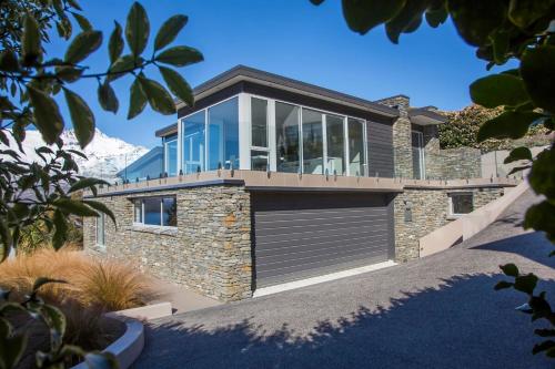 a house with a garage with glass windows at The Views and Spa 4BRM in Queenstown