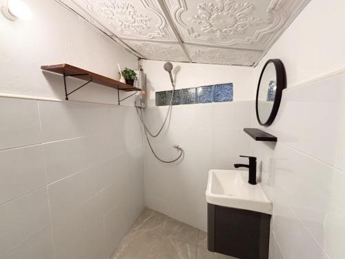 ein weißes Badezimmer mit Waschbecken und Spiegel in der Unterkunft Easy hideout in Pai