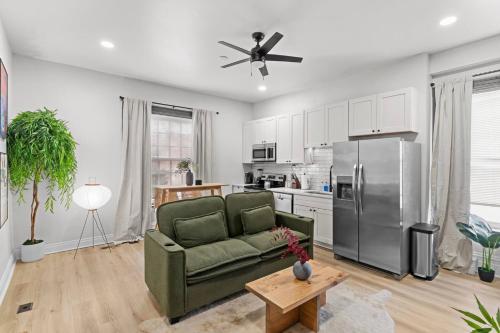 a living room with a green couch and a refrigerator at Studio Apt. Near Alamo Drafthouse, SLU & Downtown in Saint Louis