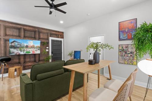 a living room with a green couch and a table at Studio Apt. Near Alamo Drafthouse, SLU & Downtown in Saint Louis