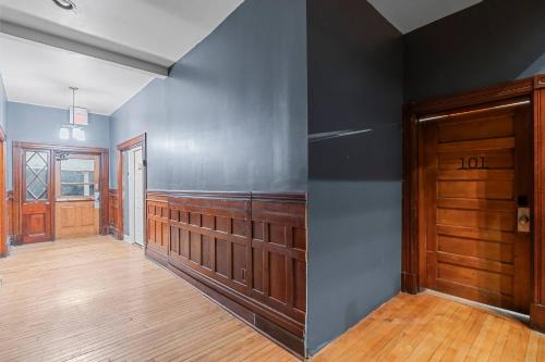 an empty room with a door and wooden floors at Studio Apt. Near Alamo Drafthouse, SLU & Downtown in Saint Louis