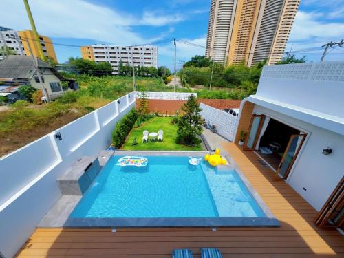 een balkon met een zwembad in een gebouw bij Villanarachaam in Cha Am