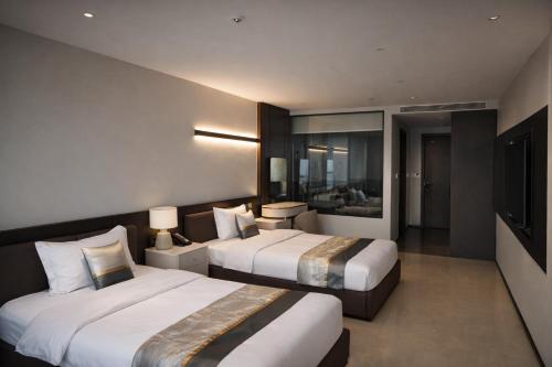 Ένα ή περισσότερα κρεβάτια σε δωμάτιο στο 绿色半岛酒店