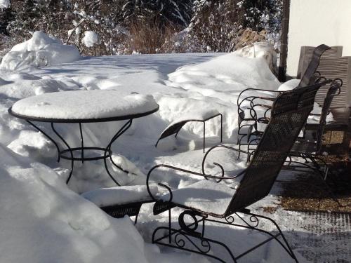 two benches and a table covered in snow at Landhausvilla Strittberg 7 in Höchenschwand
