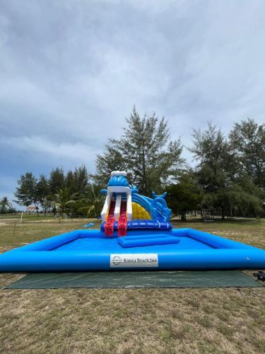 a blue inflatable water slide in a park at Kanza Beach Inn in Marang