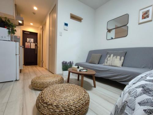 a living room with a couch and a table at ティエラ北池袋 in Tokyo