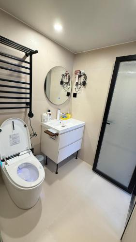 a bathroom with a toilet and a sink and a shower at WildChild in Hakuba