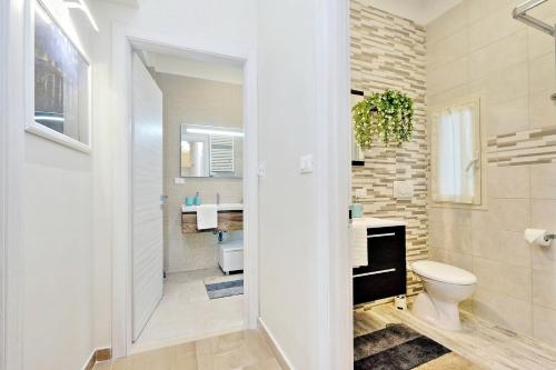 a bathroom with a toilet and a sink at Oksana's Bernadette Apartment in Rome