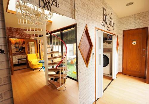 a living room with a spiral staircase in a house at Koiwa Guesthouse Tokyo in Tokyo