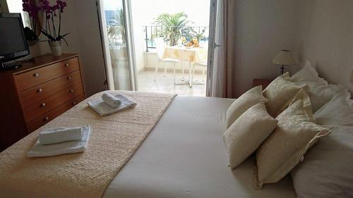 a bedroom with a bed with towels on it at Apartment Vanja in Tučepi