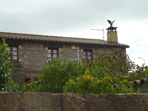a house with a bird statue on top of it at Il Nido dell'aquila in Sardara