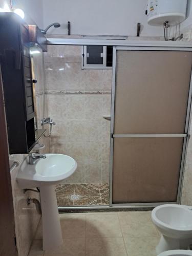a bathroom with a shower and a sink and a toilet at Ebenezer in Playa Hermosa