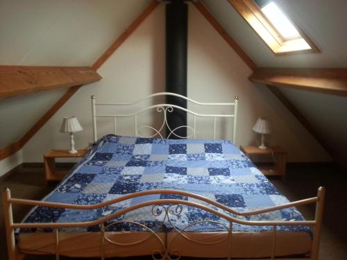 デ・ハーンにあるFerienhaus Villa-Josefinのベッドルーム1室(青と白のキルトのベッド1台付)