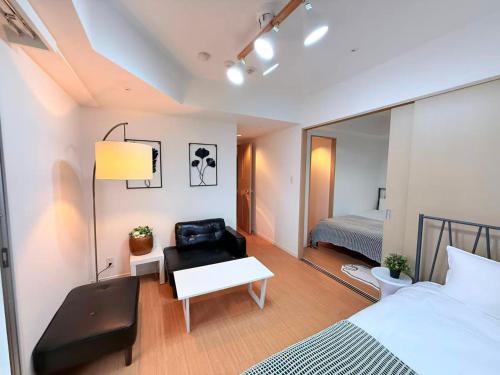 a bedroom with a bed and a chair and a mirror at Cozy APT Stay in Center Tokyo -SHIBUYA in Tokyo