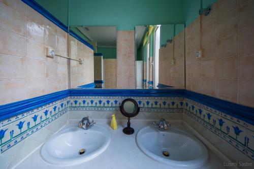 a bathroom with two sinks and a mirror at Hostel Covent Garden in León