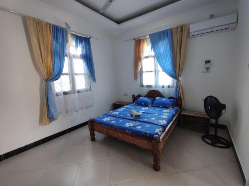 En eller flere senge i et værelse på Kwa Mzungu Villa