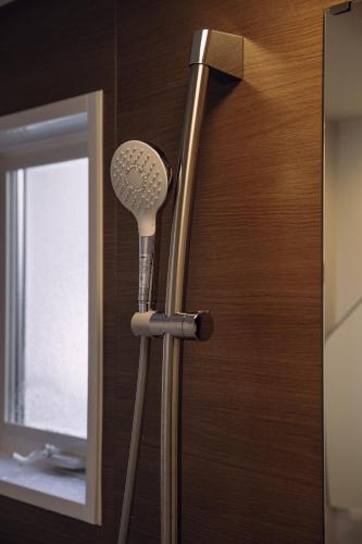 a bathroom with two blow dryers in front of a mirror at 千秋楽 in Tamano