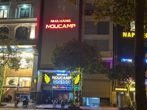 a city at night with neon signs on buildings at Hoa Hồng 301MD in Hanoi