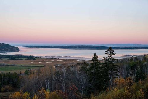a view of a body of water at sunset at 204 - Luxury Obsidian Condo - Elegance & Pool in Baie-Saint-Paul