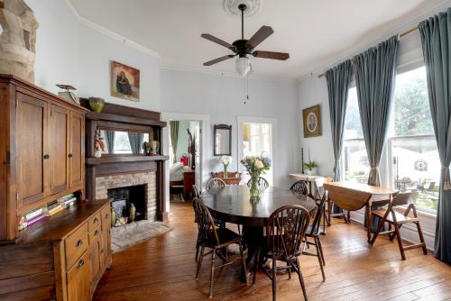 a dining room with a table and a fireplace at Heights Ironworks Bed & Breakfast in Houston